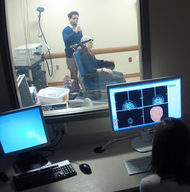 Faculty member, Fabio Ferrarelli, MD, PhD preps a research participant for Transcranial Magnetic Stimulation