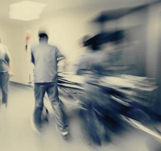 Emergency Room Doctors Rush Patient Down Hallway